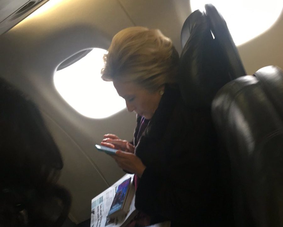 PHOTO: Hillary flies commercial, engrossed in phone - The American ...
