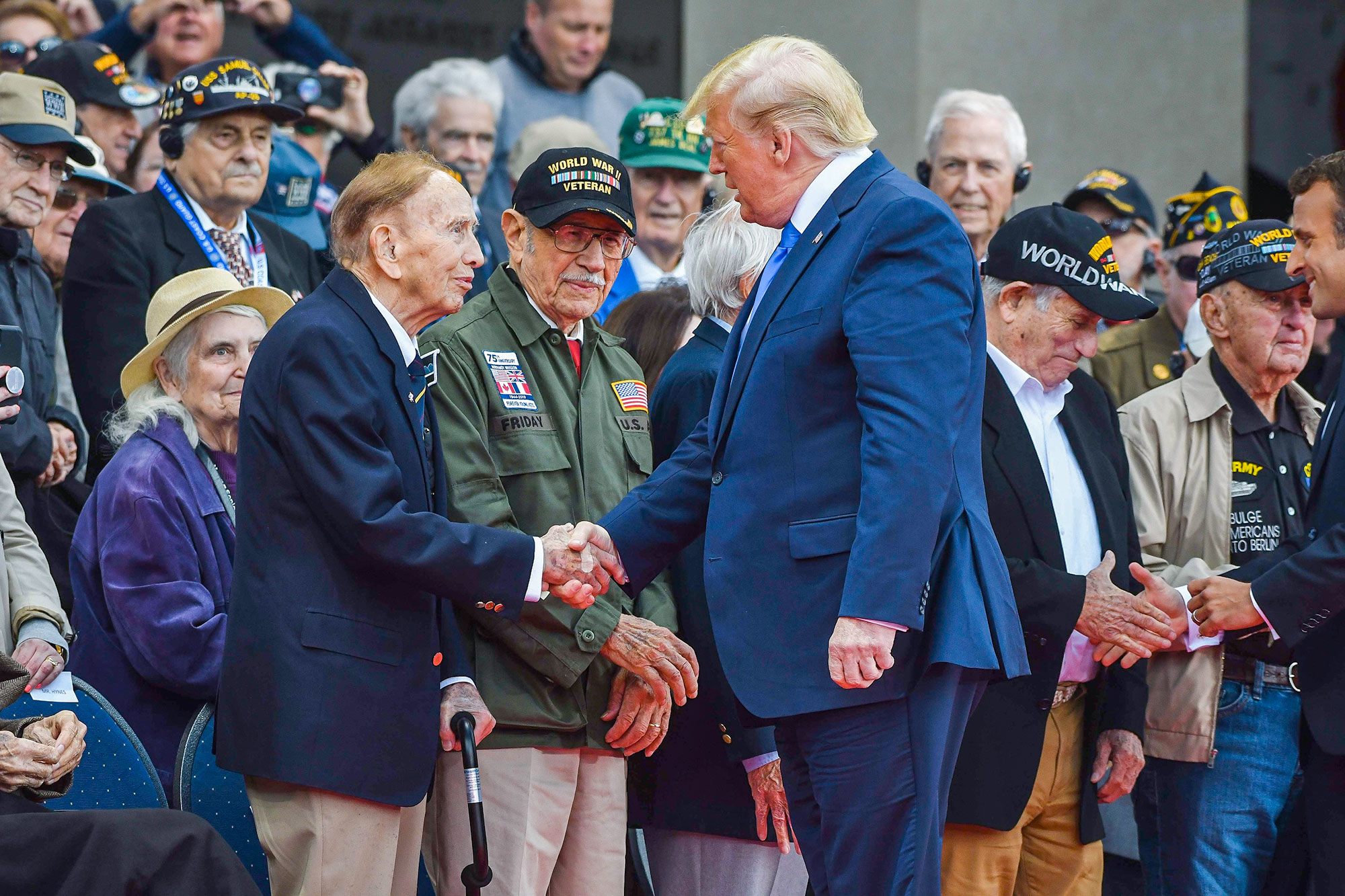 President Donald J. Trump talks with World War II veterans attending the 75th D-Day anniversary ceremony at the Normandy American Cemetery and Memorial in Colleville-sur-Mer, France, June 6, 2019.