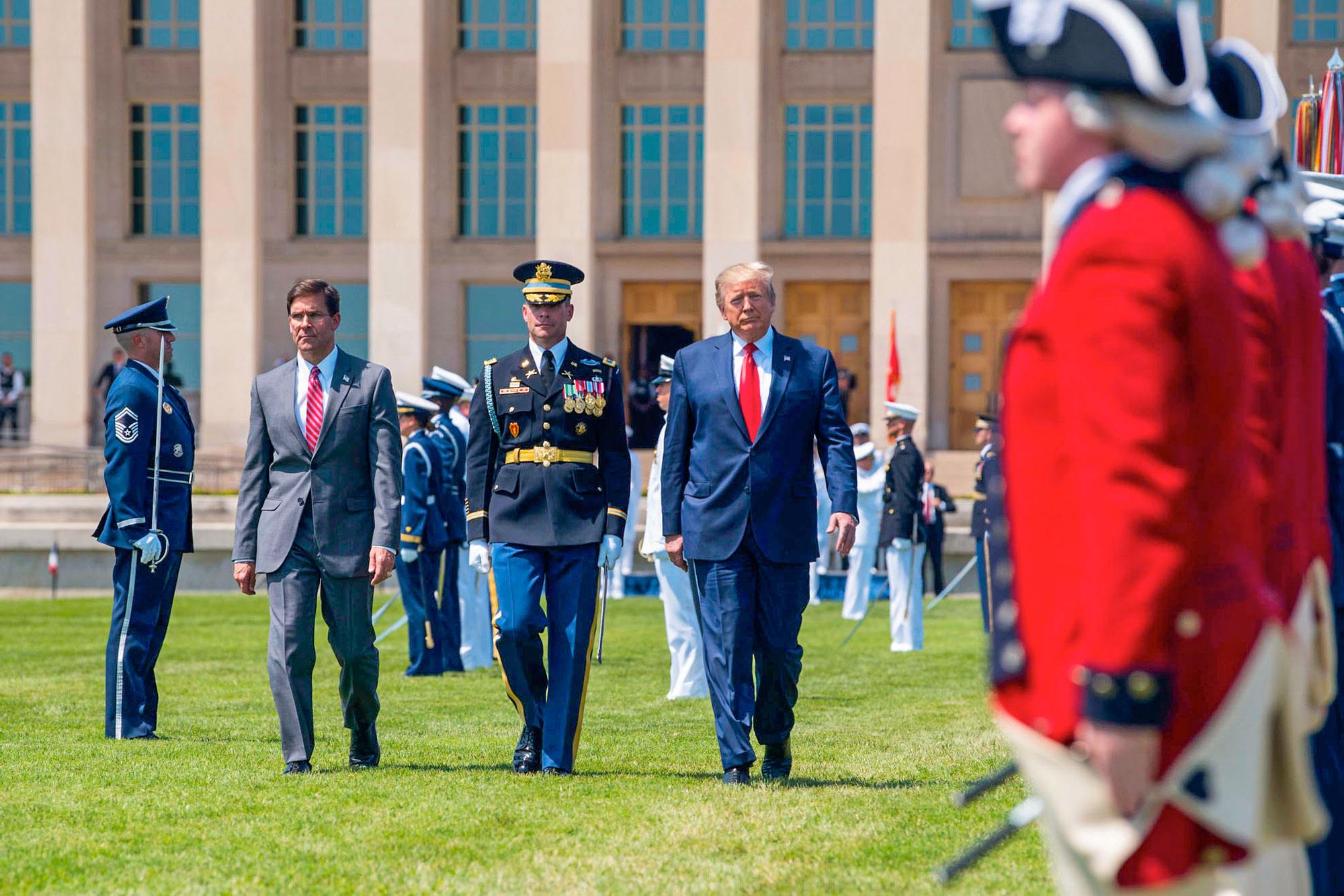 President Donald J. Trump walks with Defense Secretary Dr. Mark T. Esper during a welcome ceremony in Esper's honor at the Pentagon, July 25, 2019.