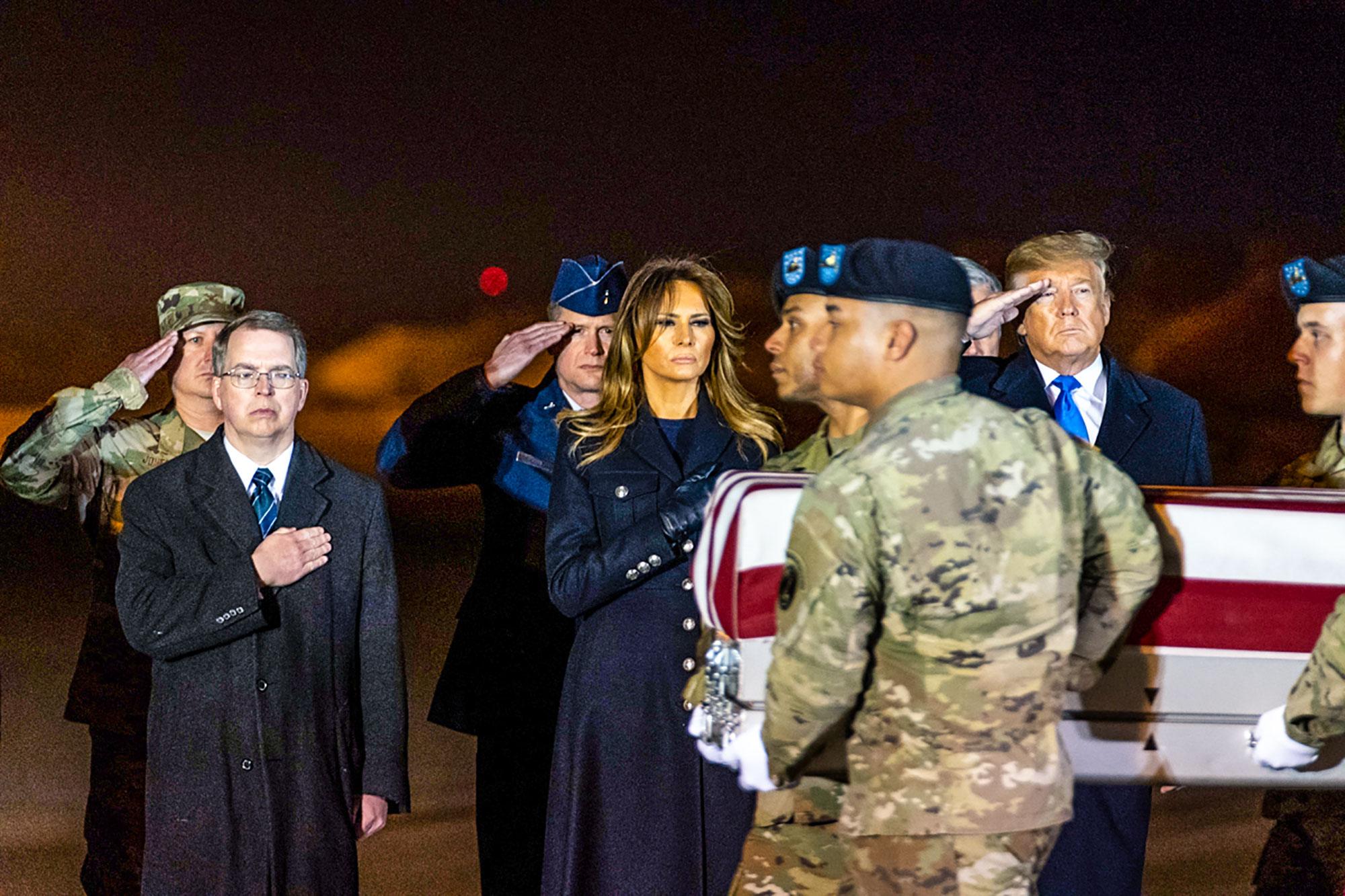 President Donald J. Trump salutes and First Lady Melania Trump places her hand over her heart during the dignified transfer ceremony for United States Army Chief Warrant Officer 2 David C. Knadle, of Tarrant, Texas, and United States Army Chief Warrant Officer 2 Kirk T. Fuchigami Jr., of Keaau, Hawaii Thursday, Nov. 21, 2019, at Dover Air Force Base in Dover, Del. Knadle and Fuchigami were killed Wednesday in a helicopter crash in Afghanistan.